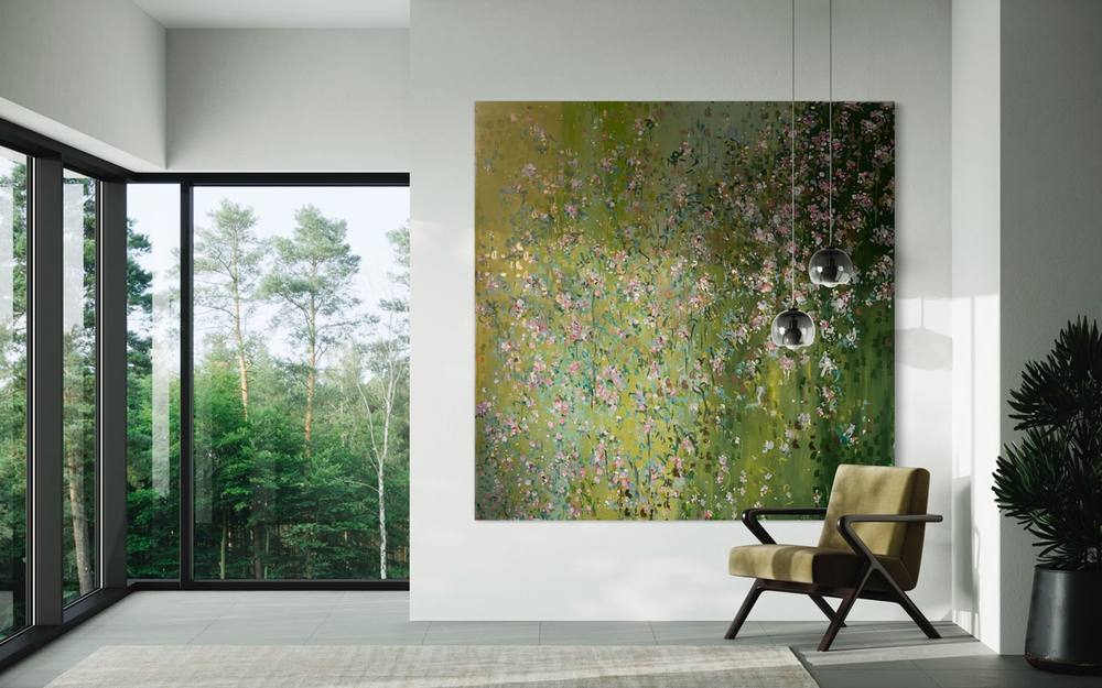 Large floral painting by Juliane Golbs in green and pink on a light wall beside floor-to-ceiling windows overlooking a forest